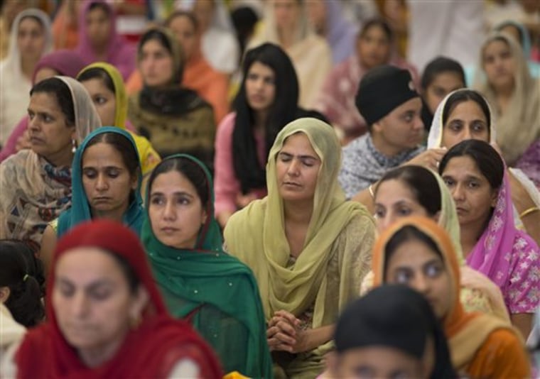 People attend a prayer service at the Sikh Temple of Wisconsin in Oak Creek, Wis., Sunday. It was the first Sunday prayer service since a man shot and killed six people there before fatally shooting himself.  